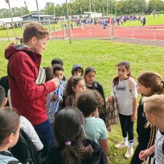 During the rain, Mr. Krage hands out the medals