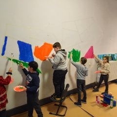 Children paint the wall