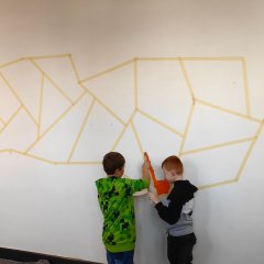 Children paint the wall