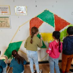 Children paint the wall