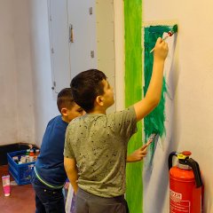 Children paint the wall