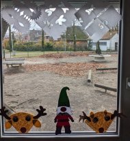 Window decorations - paper snowflakes, reindeer made from coffee filters, and handmade elves