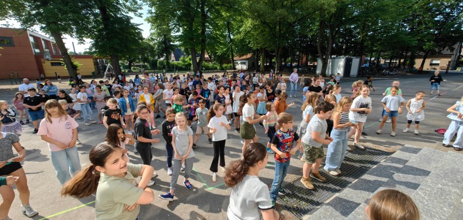 Children dance together in the sunshine